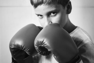 a boy with boxing gloves