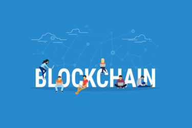 people sitting at the word blockchain